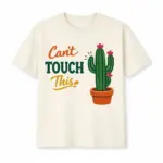 Ivory cactus shirt printed with CAN'T TOUCH THIS beside a flowering potted cactus graphic.