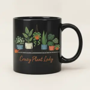 Black ceramic mug with illustrated potted plants and Crazy Plant Lady printed on the front.