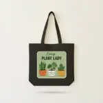 Black canvas tote bag with Crazy Plant Lady potted plants illustration printed on front.